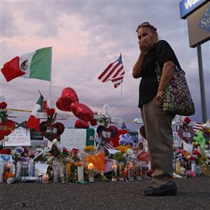 Catalina Saenz wipes tears from her face as she visits a makeshift memorial near the scene of a mass shooting at a shopping complex Tuesday, Aug. 6, 2019, in El Paso, Texas. A total of 22 people were killed and 24 injured in the massacre at the Walmart on Aug. 3.