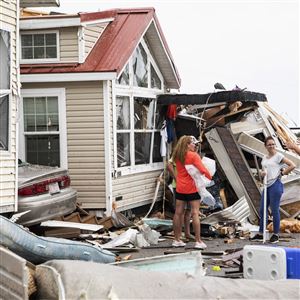 Residents of the Boardwalk RV Park discuss the path of a  tornado generated by Hurricane Dorian that struck the area Sept. 5, 2019, in Emerald Isle, N.C.