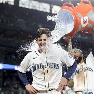 The Mariners' Cole Young is dunked with water by J.P. Crawford after reaching first on a fielder's choice that allowed Miles Mastrobuoni to score the walk-off run during the 11th inning of a game against the Minnesota Twins on Saturday, May 31, 2025, in Seattle.