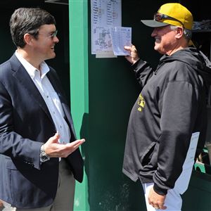 Pirates owner Bob Nutting talks with manager Clint Hurdle in the dugout before the start of a September 2013 game against the Reds.