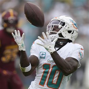 Miami Dolphins wide receiver Tyreek Hill (10) catches a touchdown pass during the first half of an NFL football game against the Washington Commanders Sunday, Dec. 3, 2023, in Landover, Md. 