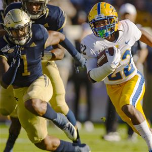 Vincent Davis (22) of the Pittsburgh Panthers rushes for a 61-yard touchdown in front of defender Juanyeh Thomas (1) of the Georgia Tech Yellow Jackets on Saturday, Nov. 2, 2019 at Bobby Dodd Stadium in Atlanta, Georgia.