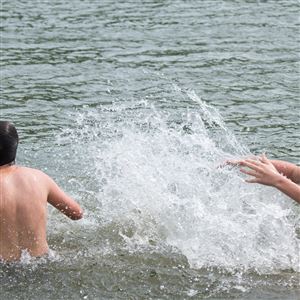 Brothers Julian Sluka, 13, of Sharpsburg, and Trenton Wooster, 15, of Etna, take advantage of the hot weather to take a dip splash in the Allegheny River on Wednesday near the Sharpsburg shore.
