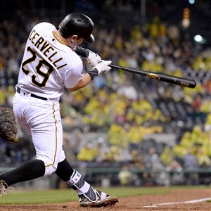  Pirates' Francisco Cervelli hits a single scoring David Freese in the fifth inning against the Reds Saturday night at PNC Park.