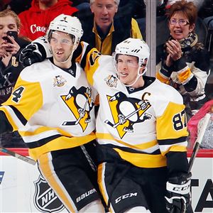 The Penguins' Justin Schultz and Sidney Crosby celebrate a goal by Schultz in the second period of Tuesday night's victory over the New Jersey Devils at Prudential Center in Newark. The Penguins return to action Wednesday against the Hurricanes back at PPG Paints Arena.