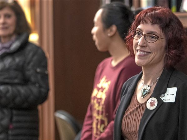 Pittsburgh author Zoje Stage, right, is introduced during a trivia night at the Carnegie Library of Pittsburgh in April 2019.   
