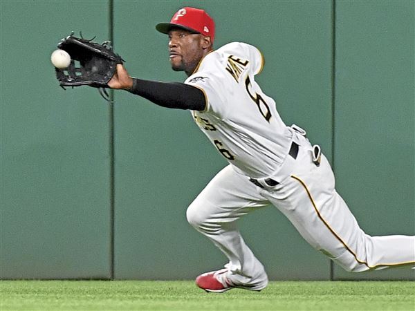 Pittsburgh Pirates' Starling Marte, left, hitches a ride to the