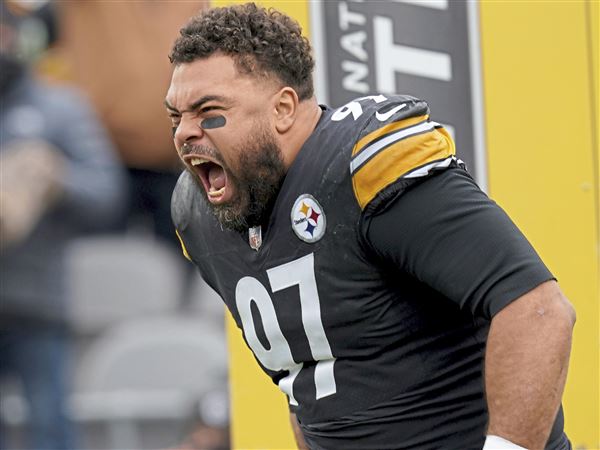 Pittsburgh Steelers defensive tackle Cameron Heyward (97) laughs as he  talks with Tampa Bay Buccaneers quarterback Tom Brady (12) after a play  during an NFL football game, Sunday, Oct. 16, 2022, in