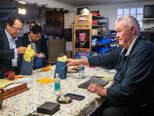 West Mifflin Mayor Chris Kelly, right, welcomed Nippon Steel Vice Chairman Takahiro Mori, left, with gifts in his office in his garage in November, 2024. Mr. Kelly said the relationship with Mr. Mori helped move the U.S. Steel-Nippon deal forward.