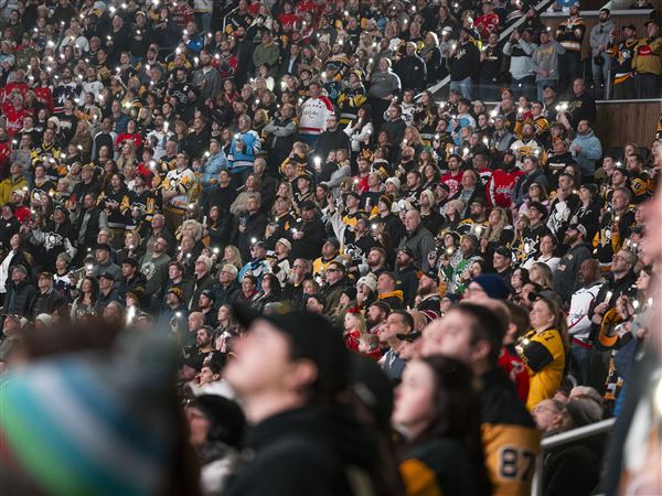 Fans use their cell phone lights during a memorial celebration of Mike Lange’s career and life at the PPG Paints Arena before the Penguins take on the Washington Capitols on Saturday, Feb. 22, 2025. Mike passed away on the 19th and was a beloved play-by-play announcer for the Pittsburgh Penguins for 46 years.