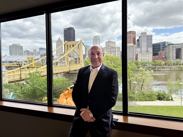 Matthews International Corp. CEO Joseph Bartolacci, shown here with the City of Pittsburgh in background at the offices on the North Shore, says the company's stock will rebound from a 52-week low.