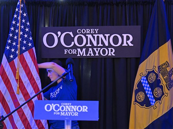 Corey O’Connor supporter and friend Julie Hallinan fixes the American flag during a watch party for Democratic Mayor Candidate at Nova place on North Side on Tuesday, May 20, 2025.