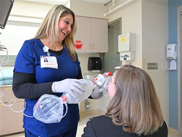 Angela Kohelis, a respiratory therapist at UPMC Presby, demonstrates a breathing treatment.