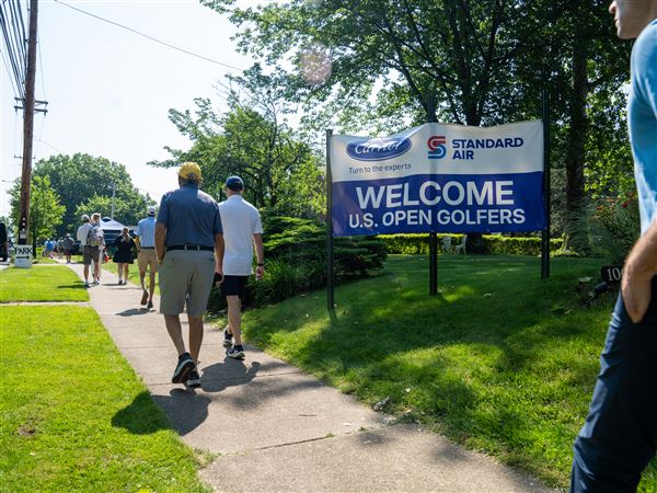 Fans walk along the road towards the 125th U.S. Open Championship in Oakmont on Wednesday, June 11, 2025. USGA officials are integrating newer technologies to help speed up the process of getting fans in the gate and around the course.