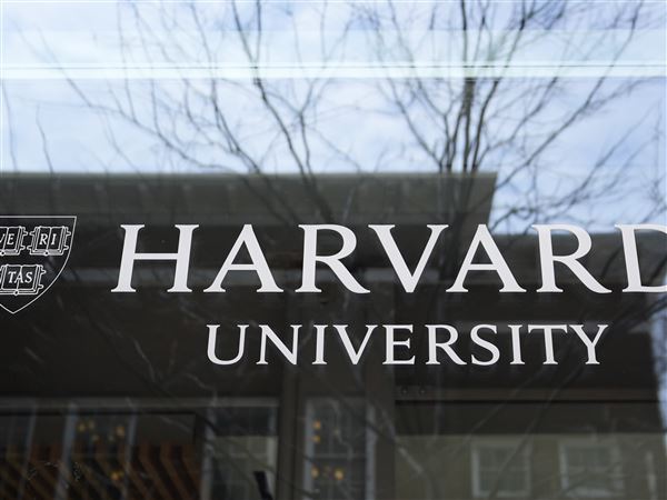 This file photo shows the Harvard University logo displayed on a building at the school, Tuesday, April 15, 2025, in Cambridge, Mass.