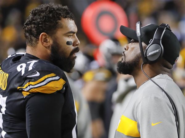 Pittsburgh Steelers head coach Mike Tomlin, right, talks with defensive end Cameron Heyward (97) in the second half of an NFL football game against the Los Angeles Chargers, Dec. 2, 2018, in Pittsburgh.