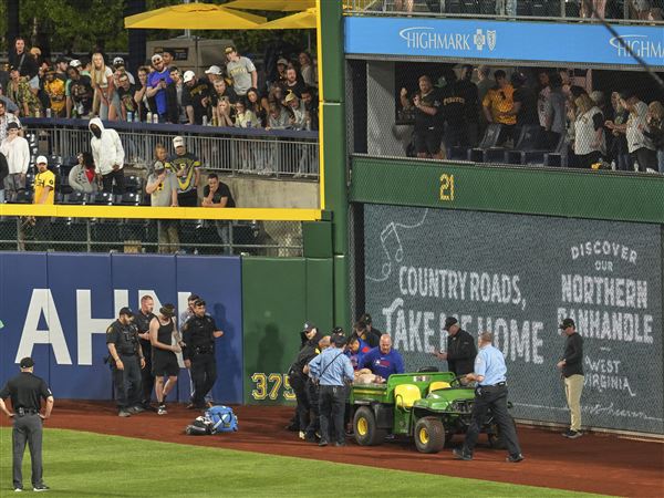 A fan is carted off the field at PNC Park after falling out of the stands during the seventh inning of a baseball game between the Pittsburgh Pirates and the Chicago Cubs in Pittsburgh, Wednesday, April 30, 2025. (AP Photo/Gene J. Puskar)