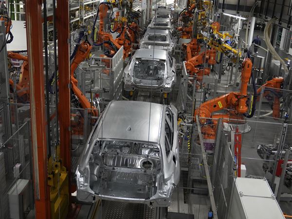 Robots work on cars of German car manufacturer BMW at an assembly line in Munich, Germany. President Donald Trump's tariff offensive led European officials on Monday to cut back their growth forecasts for this year and next.