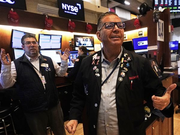 Traders Jonathan Mueller, right, and Michael Capolino work on the floor of the New York Stock Exchange on Wall Street on Wednesday, May 14, 2025, in the Financial District neighborhood of New York City’s Manhattan borough.