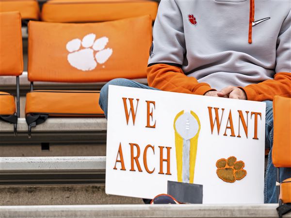A fan holds a sign referencing high school recruit Arch Manning before the game between the Clemson Tigers and the Florida State Seminoles at Clemson Memorial Stadium on October 30, 2021 in Clemson, South Carolina.