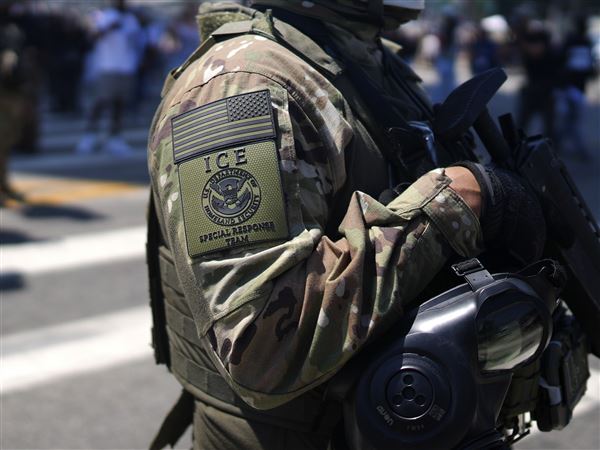 An ICE Special Response Team member stands guard outside the Metropolitan Detention Center, while protesters gathered outside to denounce ICE operations, Tuesday, June 10, 2025, in downtown Los Angeles. 