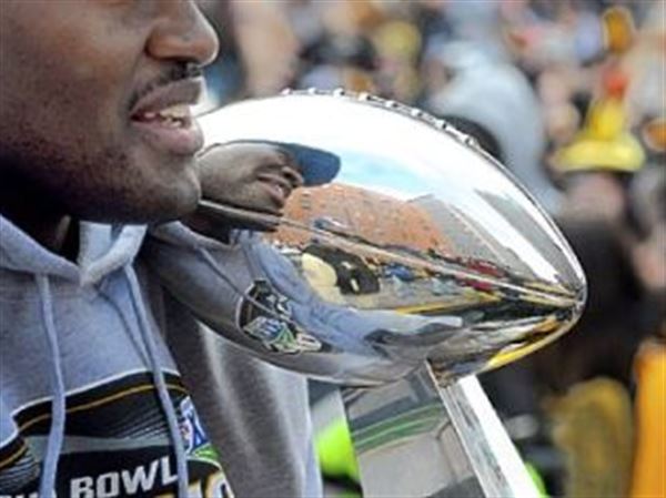 Iowan Kurt Warner walks up Lombardi Trophy at Super Bowl procession