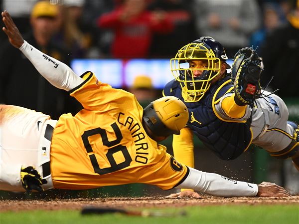 Alexander Canario of the Pittsburgh Pirates is tagged out at home plate by William Contreras of the Milwaukee Brewers during the tenth inning at PNC Park on May 23, 2025 in Pittsburgh, Pennsylvania. 