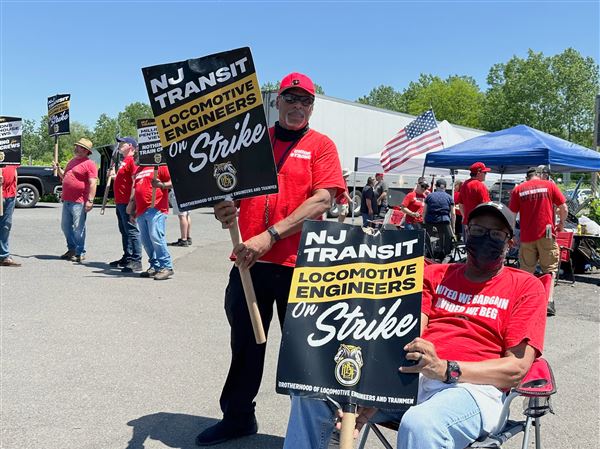 Striking members of the New Jersey Transit locomotive engineers union picket Saturday outside a rail yard in Morrisville, Pa.