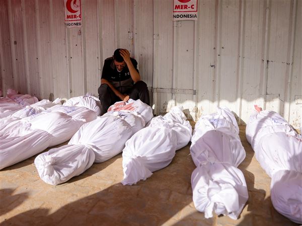 A Palestinian man reacts as he mourns among the bodies of victims of Israeli strikes on Jabalia, at the Indonesian Hospital in Beit Lahia in the northern Gaza Strip on May 14, 2025. Gaza’s civil defence agency said at least 29 people were killed and dozens wounded in Israeli strikes on the war-battered Palestinian territory on May 14.