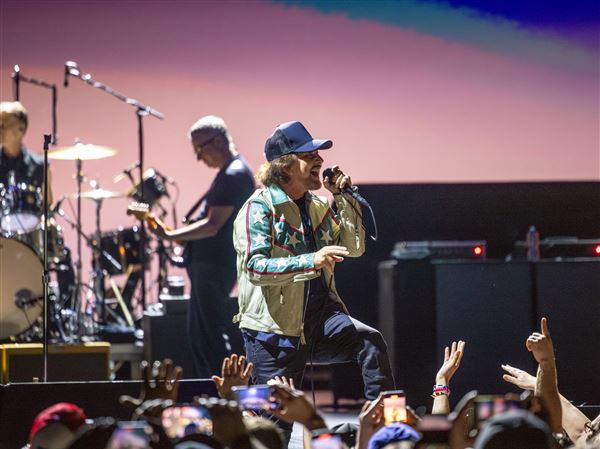 Eddie Vedder, the lead singer of Pearl Jam plays to the crowd when the band performed on their Dark Matter Tour at PPG Paints Area, Friday, May 16, 2025