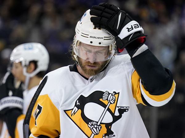 Pittsburgh Penguins' Jeff Carter (77) prepares for a face-off