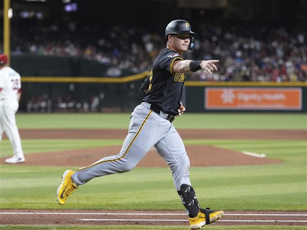 Pittsburgh Pirates' Henry Davis, right, celebrates his two-run home run against Arizona Diamondbacks starting pitcher Corbin Burnes, left, during the sixth inning of a baseball game Tuesday, May 27, 2025, in Phoenix. 