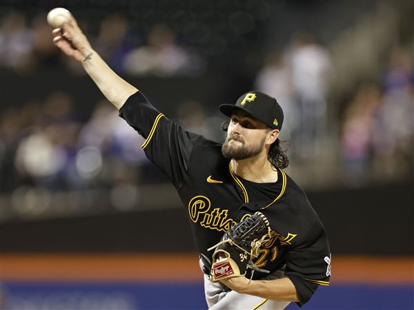 Pittsburgh Pirates starting pitcher JT Brubaker, left, tags out