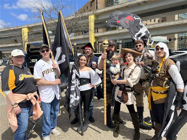 Pittsburgh Pirates fans wave the Jolly Roger flag on the rotunda as the  standing room only crowd at PNC Park watches the ten inning opening day 1-0  win over the Chicago Cubs