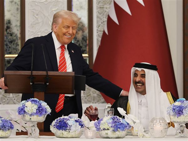 President Donald Trump jokes with Qatar’s ruling emir, Sheikh Tamim bin Hamad Al Thani, as they attend a state dinner at the Lusail Palace on Wednesday, May 14, 2025, in Doha, Qatar.