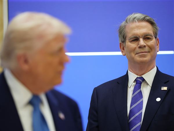 President Donald Trump speaks alongside Treasury Secretary Scott Bessent, right, during a U.S.-UAE Investment Forum at Qasr al-Watan — the presidential palace of the United Arab Emirates — on Friday, May 16, 2025, in Abu Dhabi.