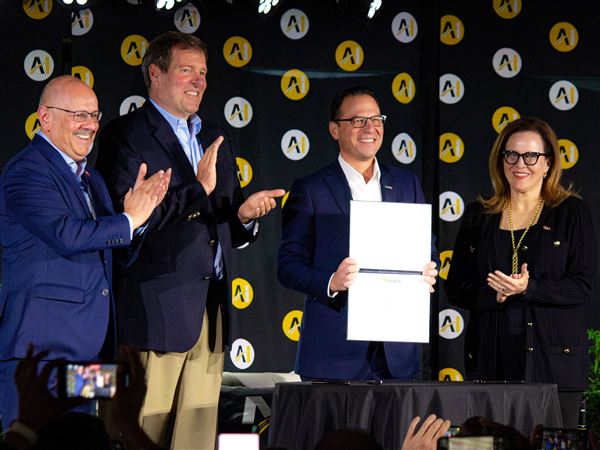 Pennsylvania Gov. Josh Shapiro displays a signed agreement with Carnegie Mellon president Farnam Jahanian, Vice President of Nvidia Federal Anthony Robbins, and University of Pittsburgh Chancellor Joan Gabel at Monday’s AI Horizons summit in Bakery Square. 
