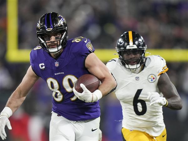 Baltimore Ravens tight end Mark Andrews runs after making a catch as Pittsburgh Steelers linebacker Patrick Queen (6) tries to stop him during the first half of an NFL wild-card playoff football game, Saturday, Jan. 11, 2025, in Baltimore.