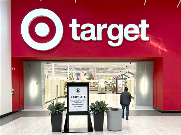 A shopper walks into a Target store in Lakewood, Colo. The Minneapolis-based retailer predicts sales will be down mid-single digits for the year as consumers tighten their budgets over fears of rising prices brought on by President Donald Trump's tariffs. 