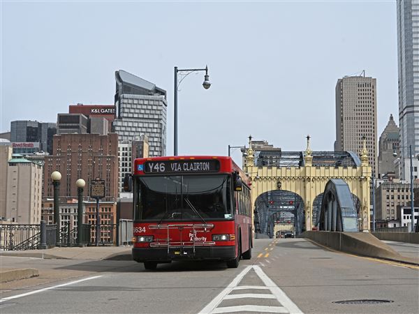 A Pittsburgh Regional Transit (PRT) bus crosses the Smithfield Street Bridge by Station Square Sunday, March 23, 2025. 