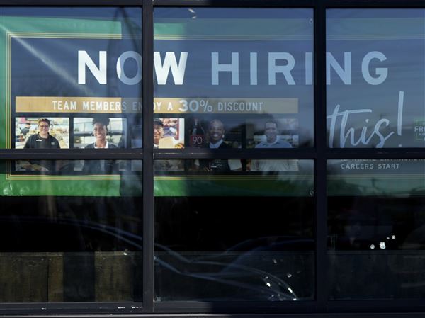 A hiring sign is displayed at a grocery store in Northbrook, Ill., Tuesday, Jan. 21, 2025. New applications for jobless benefits numbered 248,000 for the week ending June 7, the Labor Department said Thursday.