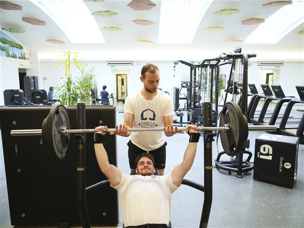 Personal trainer Valerio Masella, 26, who trained Robert Francis Prevost before the cardinal became Pope Leo XIV, helps his colleague Giorgio Vaccarella in his gym near the Vatican, May 21, 2025. 