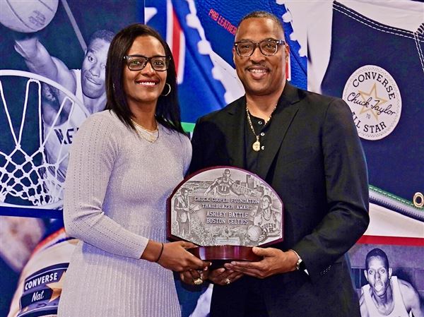 Ashley Battle receiving Trailblazer Award from Chuck Cooper III. 