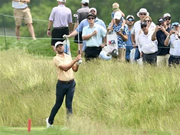 The gallery watches Sam Burns take a swing on the ninth hole during the second round of the U.S. Open golf tournament at Oakmont Country Club Friday, June 13, 2025.