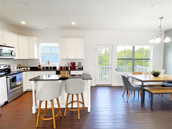 The kitchen and dining area in a Muirfield three-bedroom townhome at Highland Village in Ross.