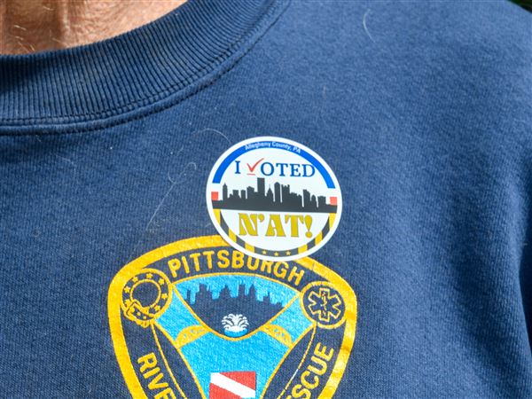 Mark Schneider, a retired Pittsburgh paramedic of 33 years, wears his "I voted" sticker while leaving the polling place at Mifflin Elementary School on Tuesday, May 20.