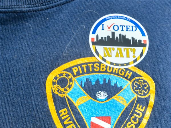 Mark Schneider, a retired Pittsburgh paramedic of 33 years, wears his "I voted" sticker while leaving the polling place at Mifflin Elementary School on Tuesday, May 20.