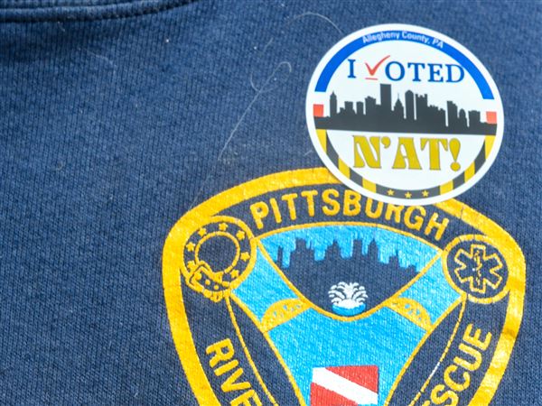 Mark Schneider, a retired Pittsburgh paramedic of 33 years, wears his "I voted" sticker while leaving the polling place at Mifflin Elementary School on Tuesday, May 20.