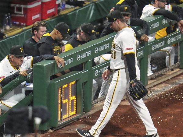 Pirates pitcher David Bednar walks to the dugout after being removed during the eighth inning against the Reds on Monday. Bednar allowed two earned runs to open the floodgates for the Reds.