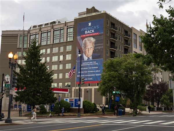 A banner of President Donald Trump hangs on the Heritage Foundation building near the U.S. Capitol. His Project Esther exploits opposition to anti-Semitism to advance his political goals. In it, Michele Goldberg argues, "ultra-Zionist gentiles get to lecture Jews about antisemitism even as they lay waste to the liberal culture that has allowed American Jews to thrive."